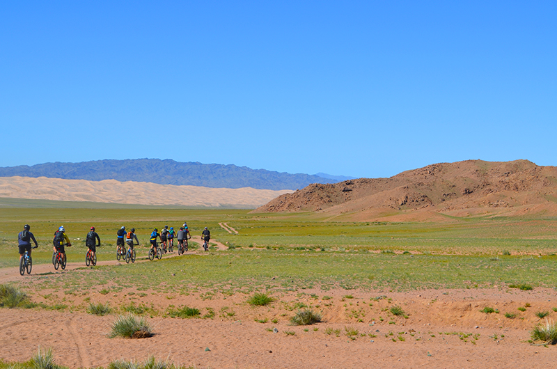 Cycling at Khongor sand dunes in Mongolian gobi desert